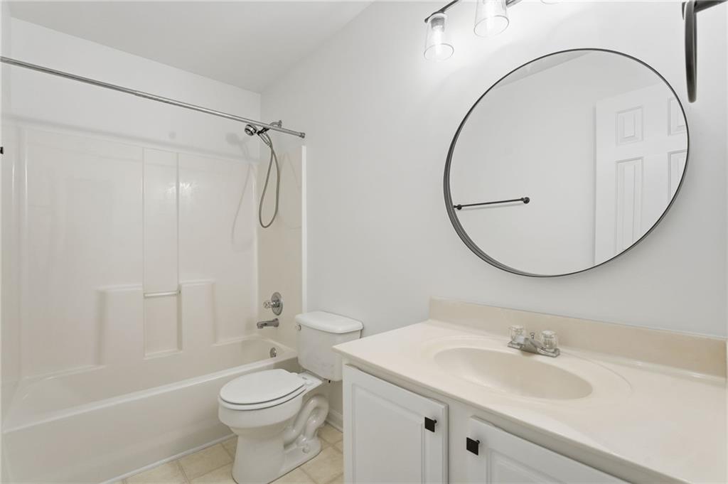 205 Towne Ridge Drive Woodstock, GA 30188 - Photo 45 of 56 a bathroom with a sink a toilet and a mirror