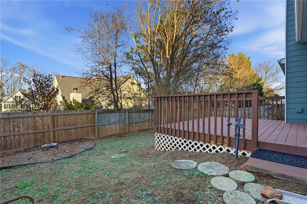 205 Towne Ridge Drive Woodstock, GA 30188 - Photo 50 of 56 a view of a yard with a fence and trees