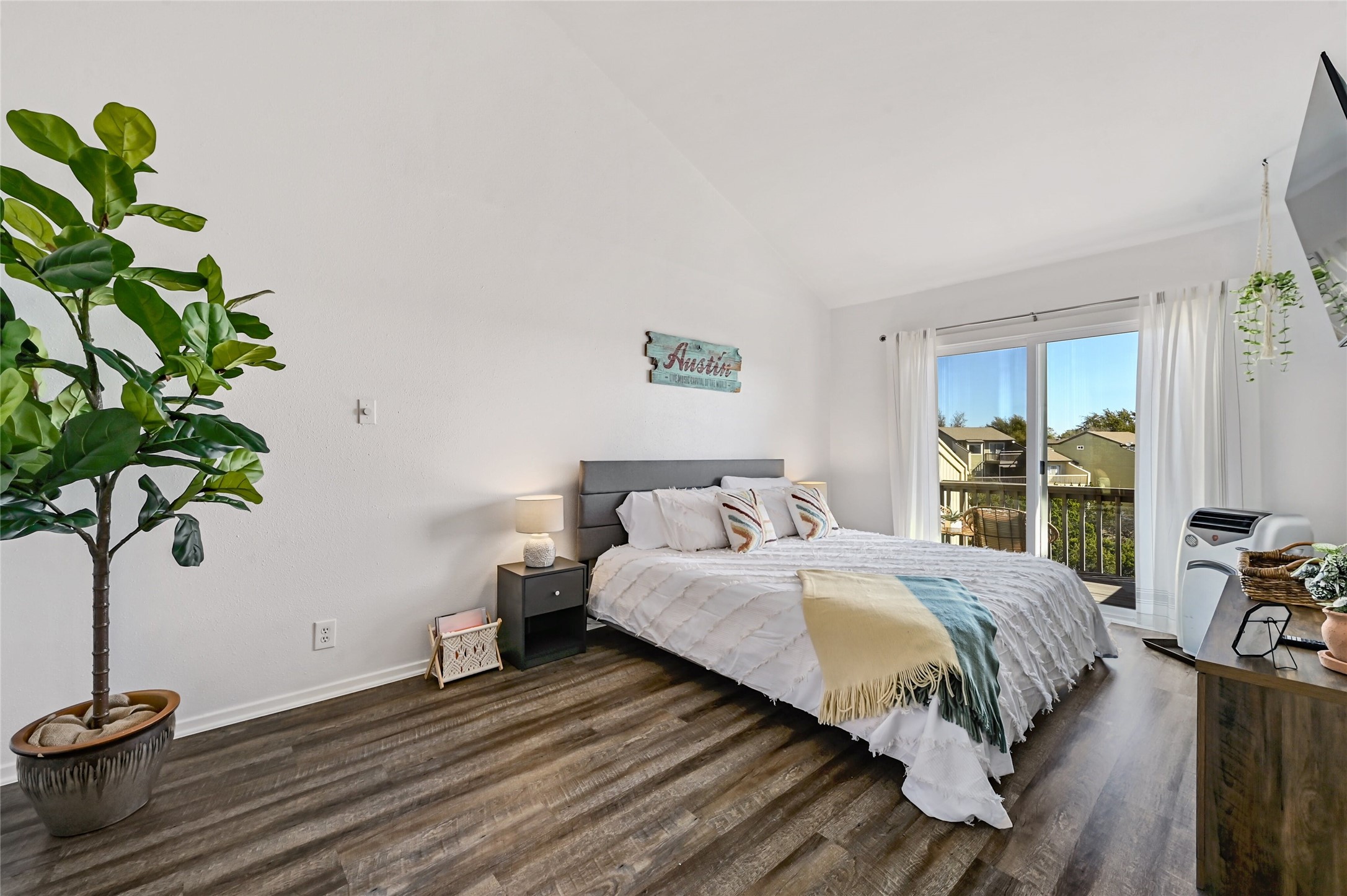 115 Comanche Drive Point Venture, TX 78645 - Photo 20 of 40 a bedroom with a bed table flowerpot and a window