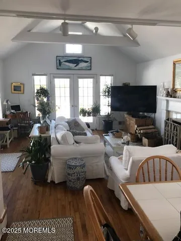 a living room with furniture a mirror and a table