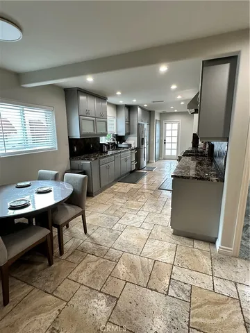 a kitchen with stainless steel appliances kitchen island granite countertop a sink and cabinets