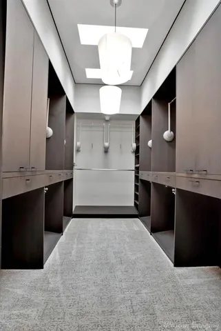 a bedroom with a bed and large windows