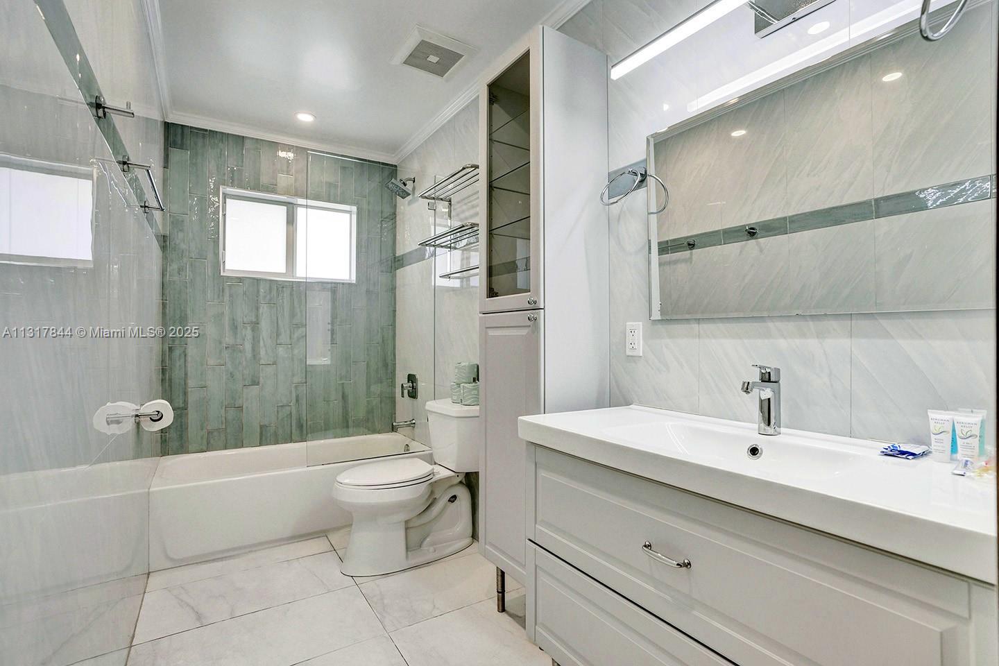 1301 Rodman Street Hollywood, FL 33019 - Photo 15 of 48 a bathroom with a sink a toilet and shower
