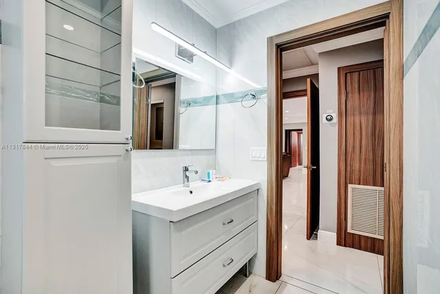 a bedroom with two beds and a chandelier