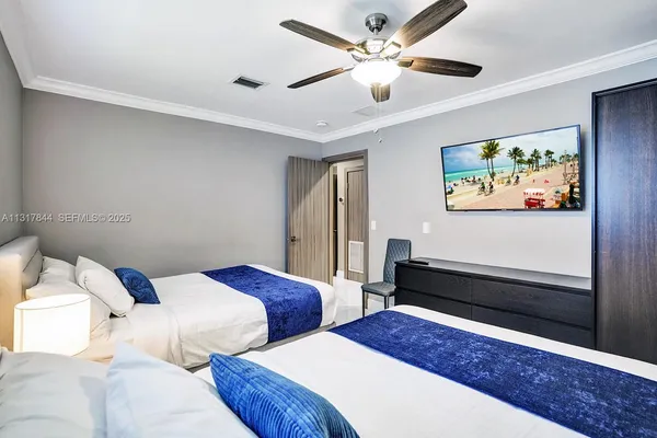 a bedroom with a bed and a painting on the wall