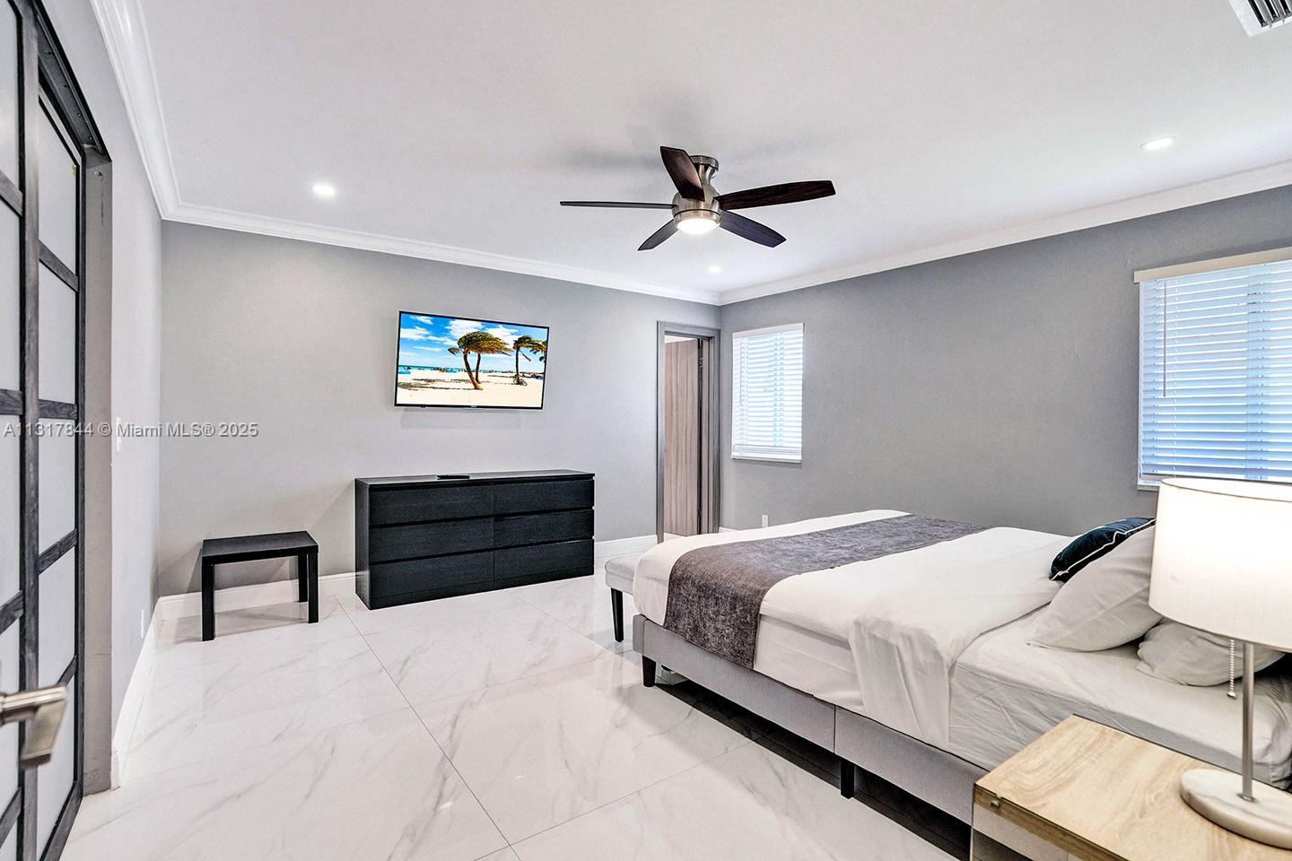 1301 Rodman Street Hollywood, FL 33019 - Photo 19 of 48 a bedroom with a bed and a painting on the wall