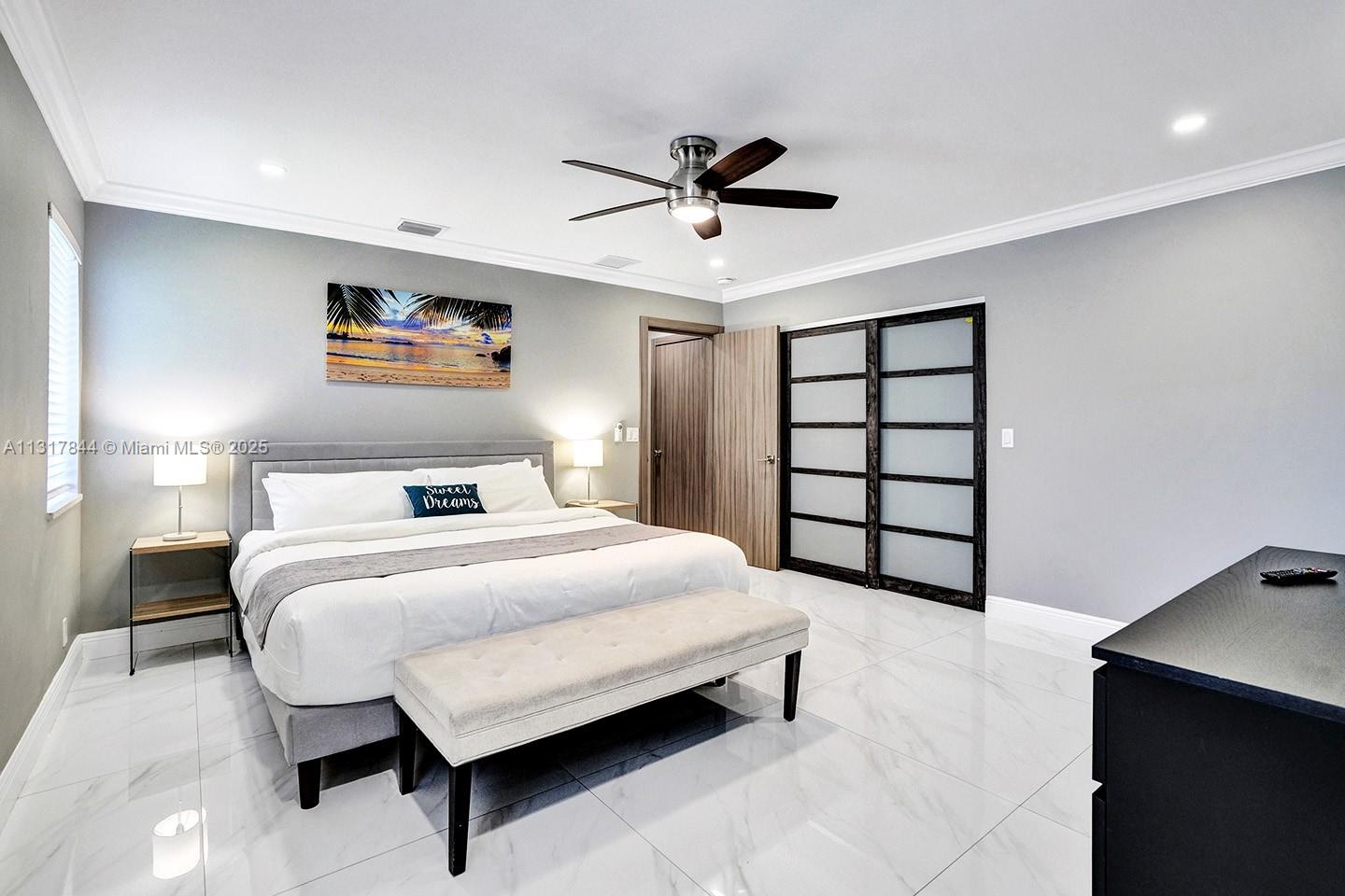 1301 Rodman Street Hollywood, FL 33019 - Photo 20 of 48 a bedroom with a bed and a chandelier