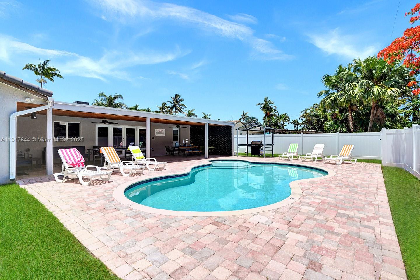 1301 Rodman Street Hollywood, FL 33019 - Photo 2 of 48 a view of a house with swimming pool and sitting area
