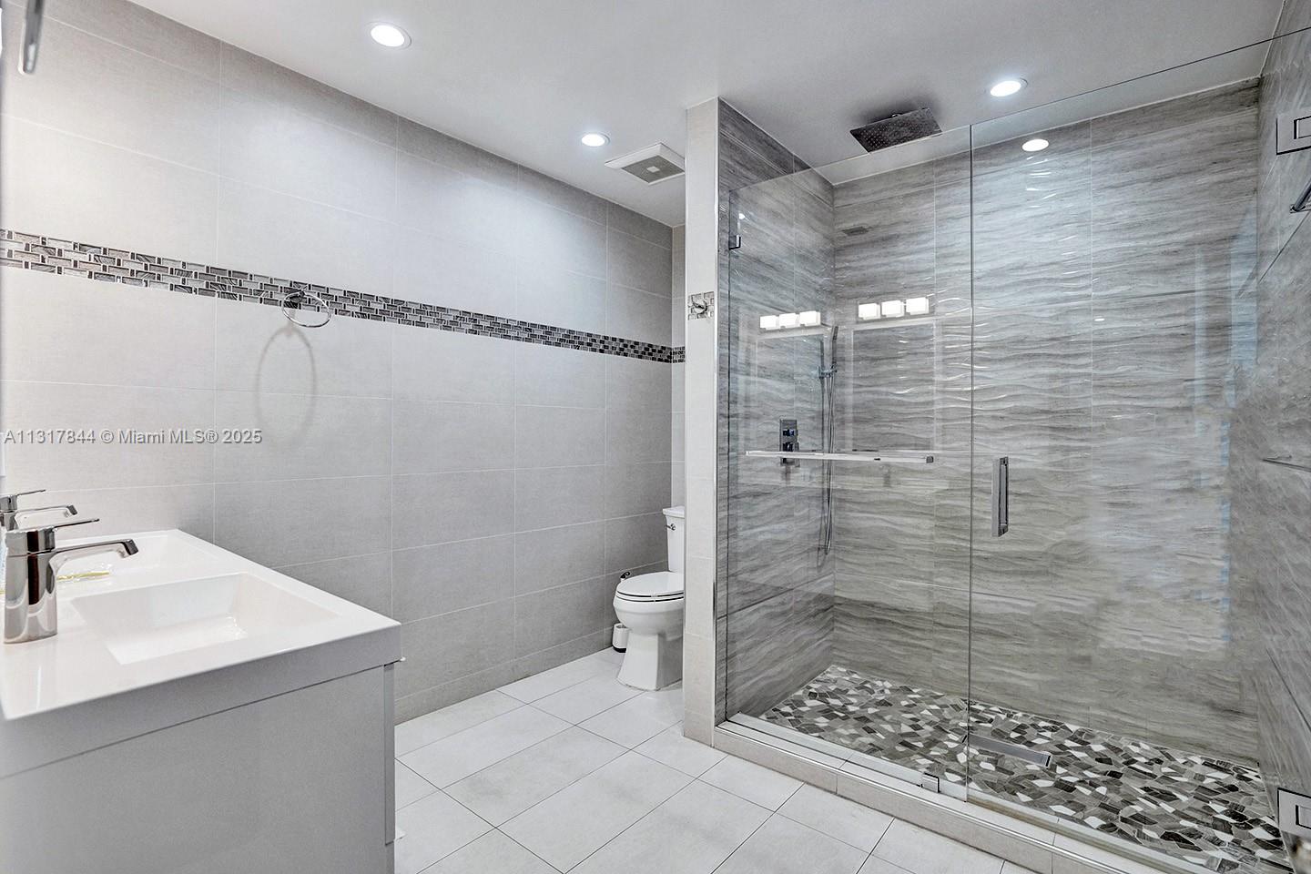 1301 Rodman Street Hollywood, FL 33019 - Photo 21 of 48 a bathroom with a shower a toilet and sink