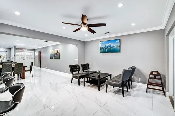 a living room with stainless steel appliances kitchen island granite countertop furniture and a kitchen view