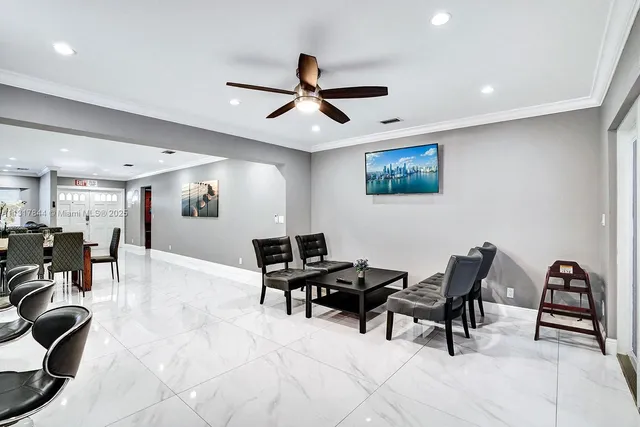 a living room with stainless steel appliances kitchen island granite countertop furniture and a kitchen view