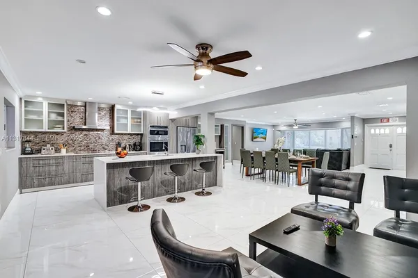 a kitchen with stainless steel appliances kitchen island granite countertop a sink and cabinets