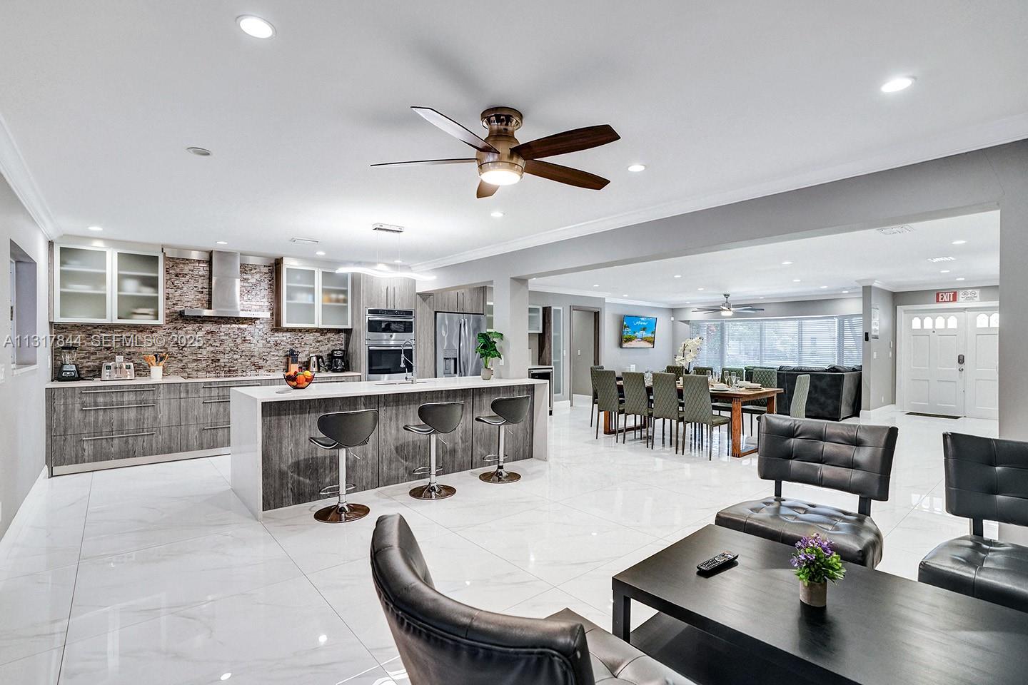 1301 Rodman Street Hollywood, FL 33019 - Photo 26 of 48 a living room with stainless steel appliances kitchen island granite countertop furniture and a kitchen view
