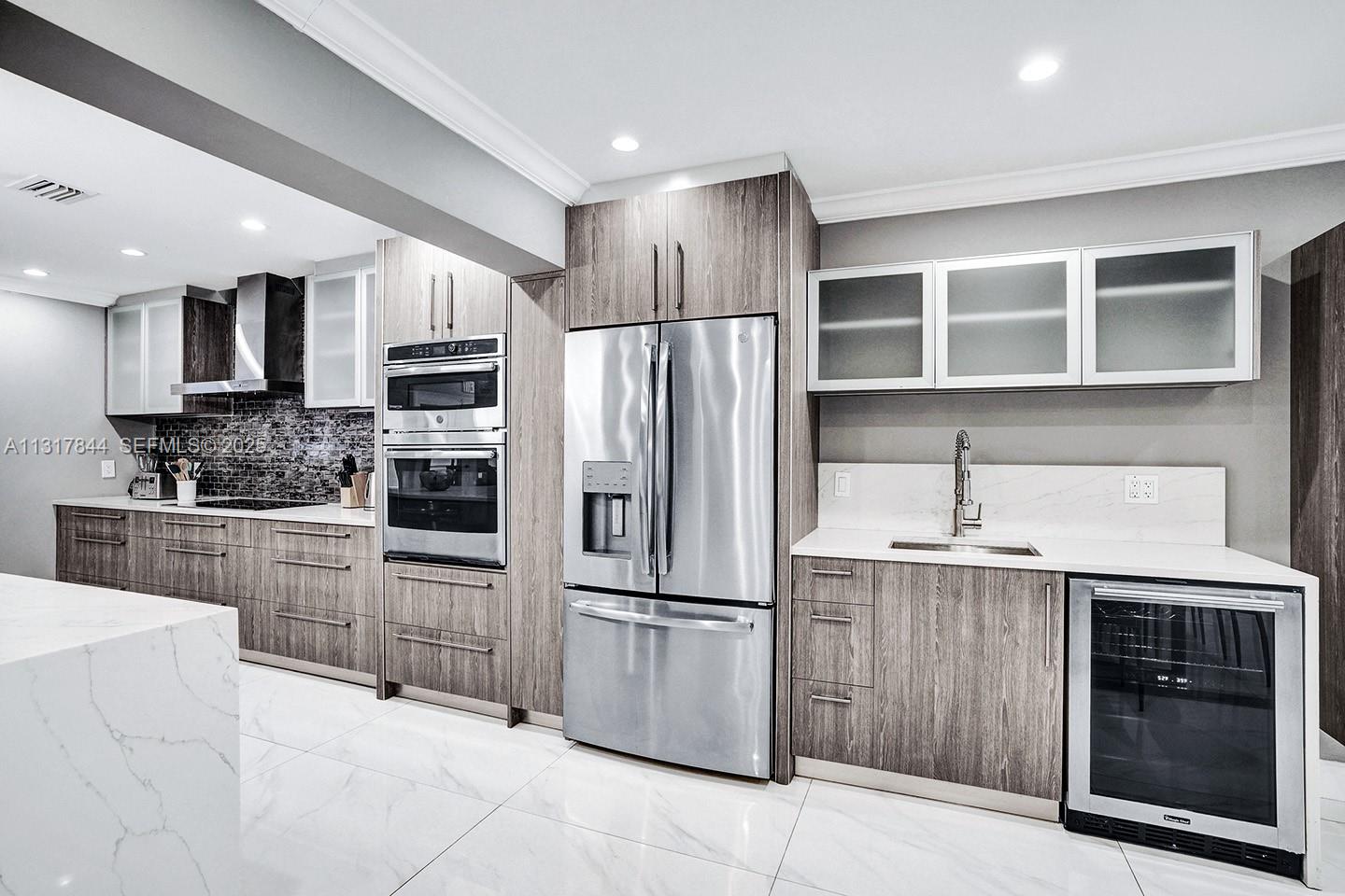 1301 Rodman Street Hollywood, FL 33019 - Photo 29 of 48 a kitchen with granite countertop a refrigerator and a stove top oven
