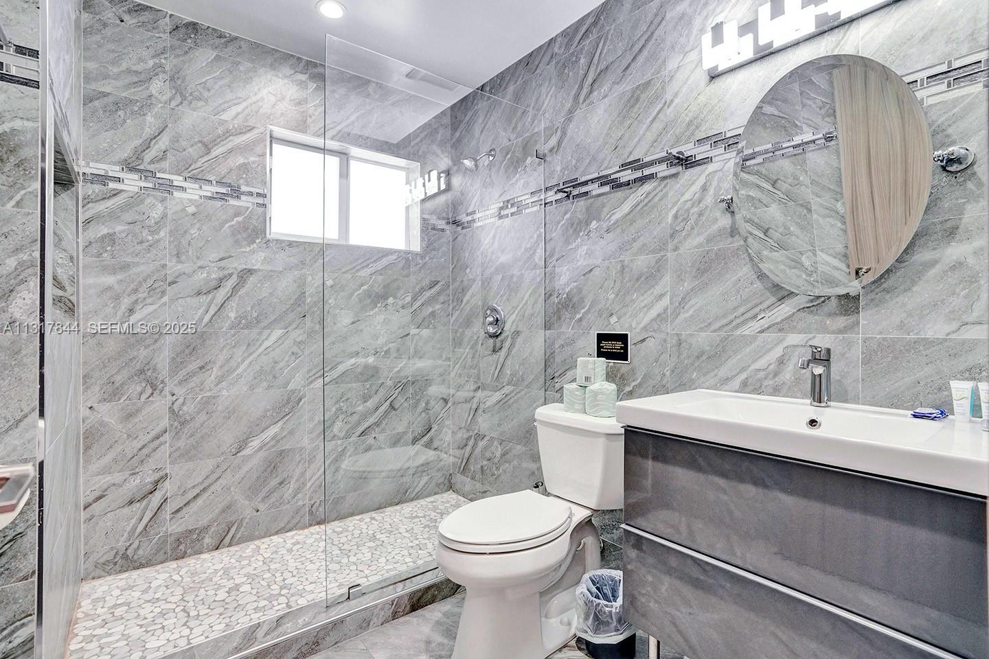 1301 Rodman Street Hollywood, FL 33019 - Photo 35 of 48 a bathroom with a sink a toilet and shower