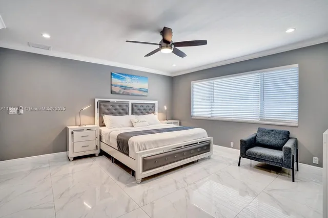 a bedroom with a bed and a ceiling fan