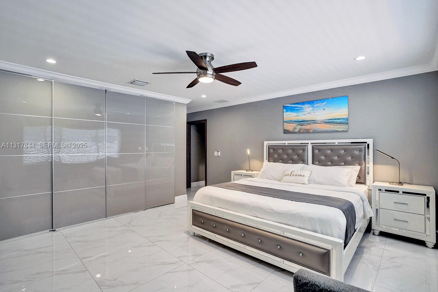 1301 Rodman Street Hollywood, FL 33019 - Photo 38 of 48 a bedroom with a bed and a ceiling fan