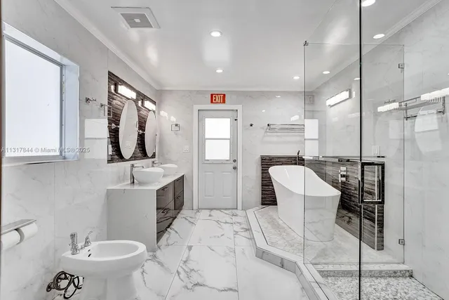 a bathroom with a double vanity sink mirror and toilet