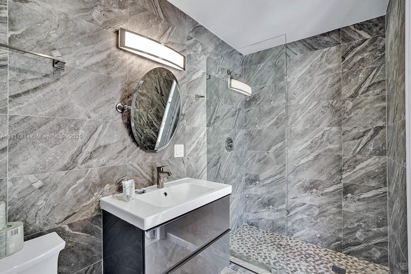 1301 Rodman Street Hollywood, FL 33019 - Photo 44 of 48 a bathroom with a sink and a mirror