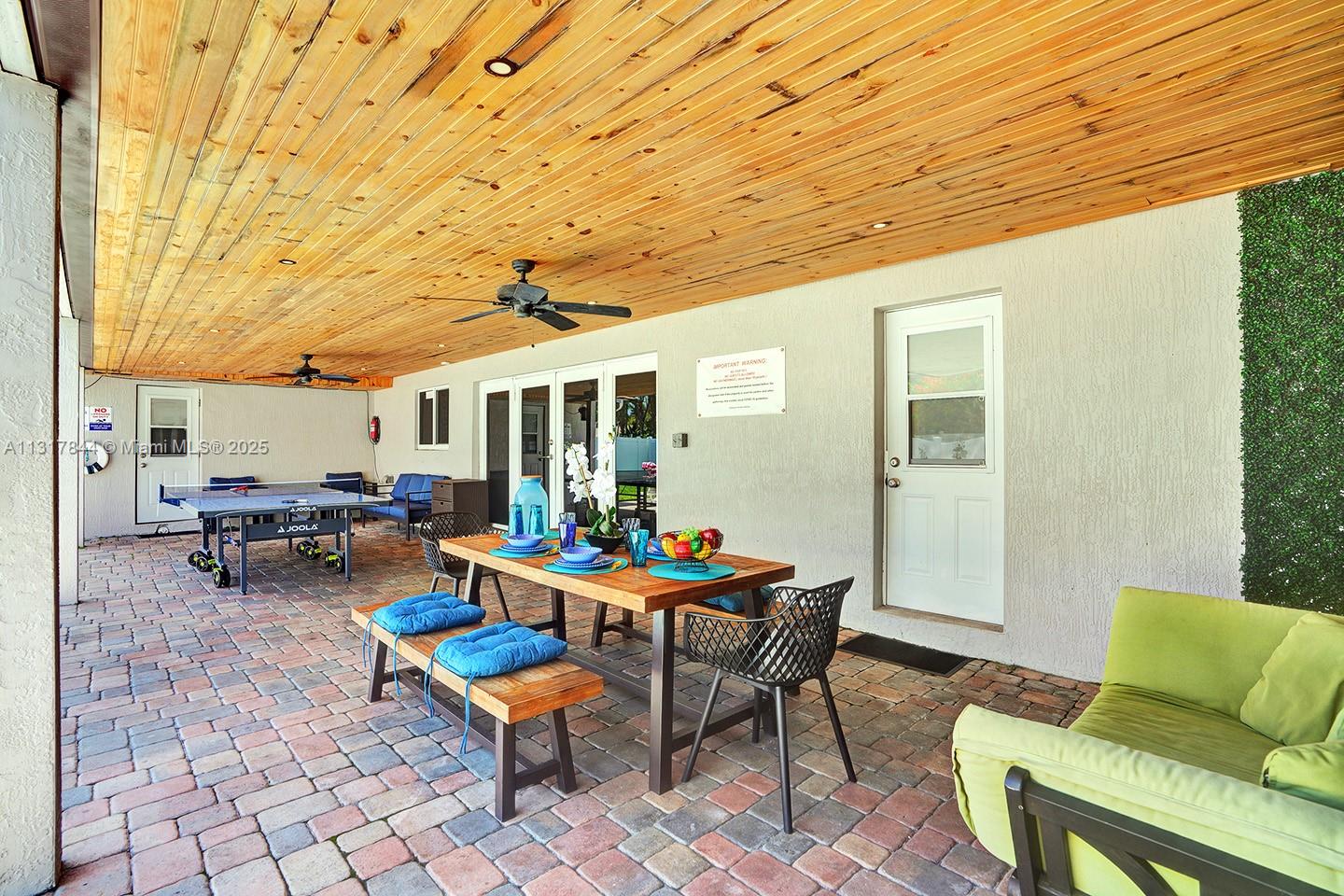 1301 Rodman Street Hollywood, FL 33019 - Photo 8 of 48 a backyard of a house with outdoor seating