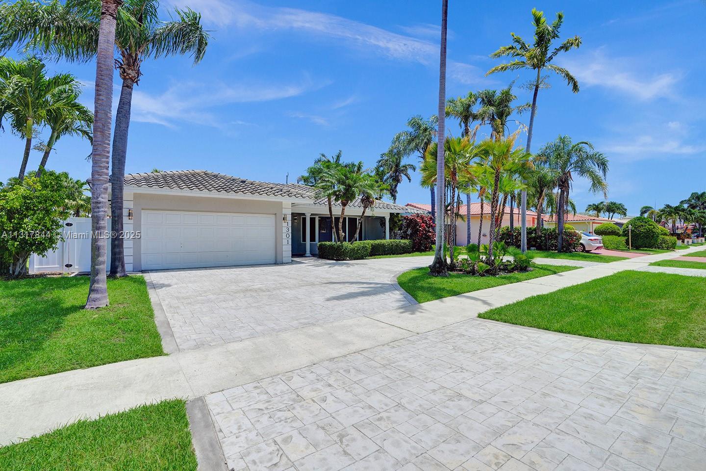 1301 Rodman Street Hollywood, FL 33019 - Photo 10 of 48 a front view of a house with a garden and a yard