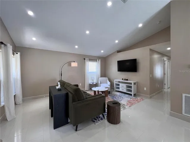 a kitchen with stainless steel appliances granite countertop a refrigerator and a stove