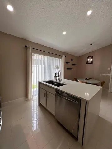 a kitchen with a sink and stove