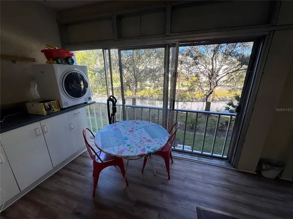 a view of a room with furniture window and wooden floor