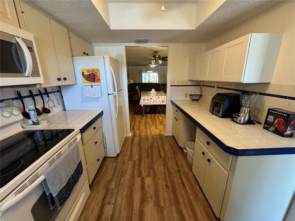 a kitchen with sink cabinets and wooden floor