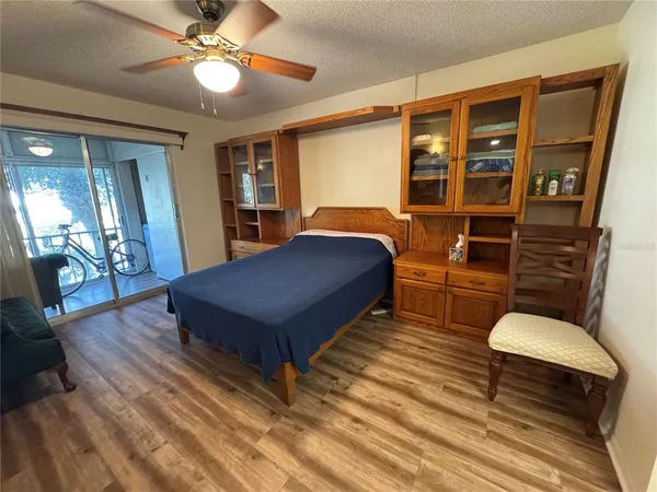 a bedroom with a bed dresser and a window