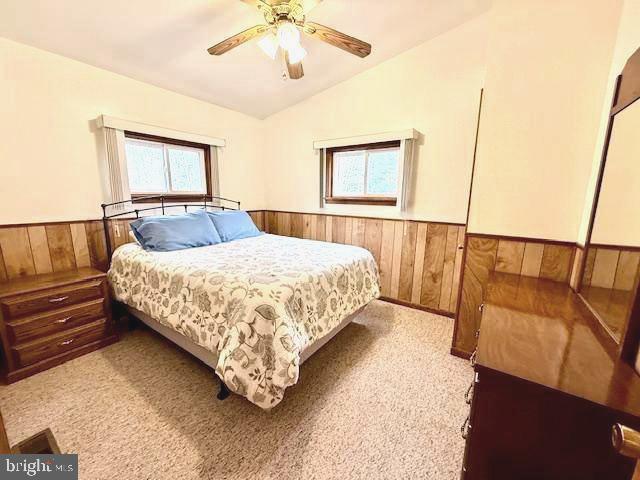 222 Skippers Point Road Oakland, MD 21550 - Photo 32 of 57 a bedroom with a bed and a chandelier