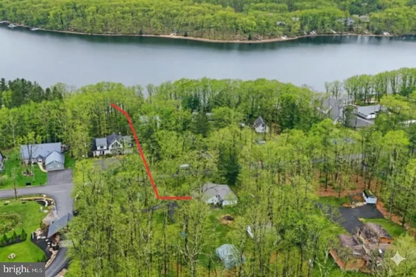 an aerial view of a house with swimming pool and outdoor space