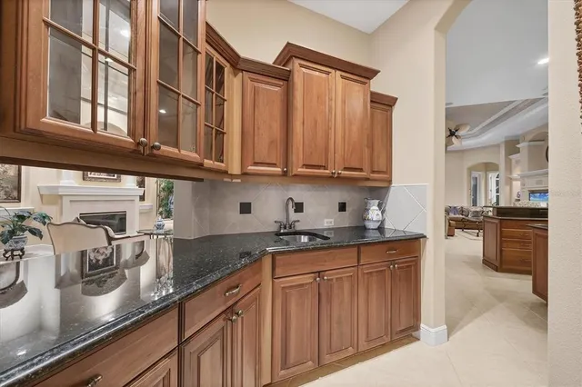 a kitchen with stainless steel appliances granite countertop a sink stove and cabinets