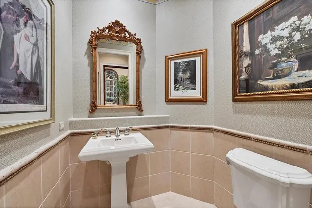 a spacious bedroom with a bed a dresser and windows