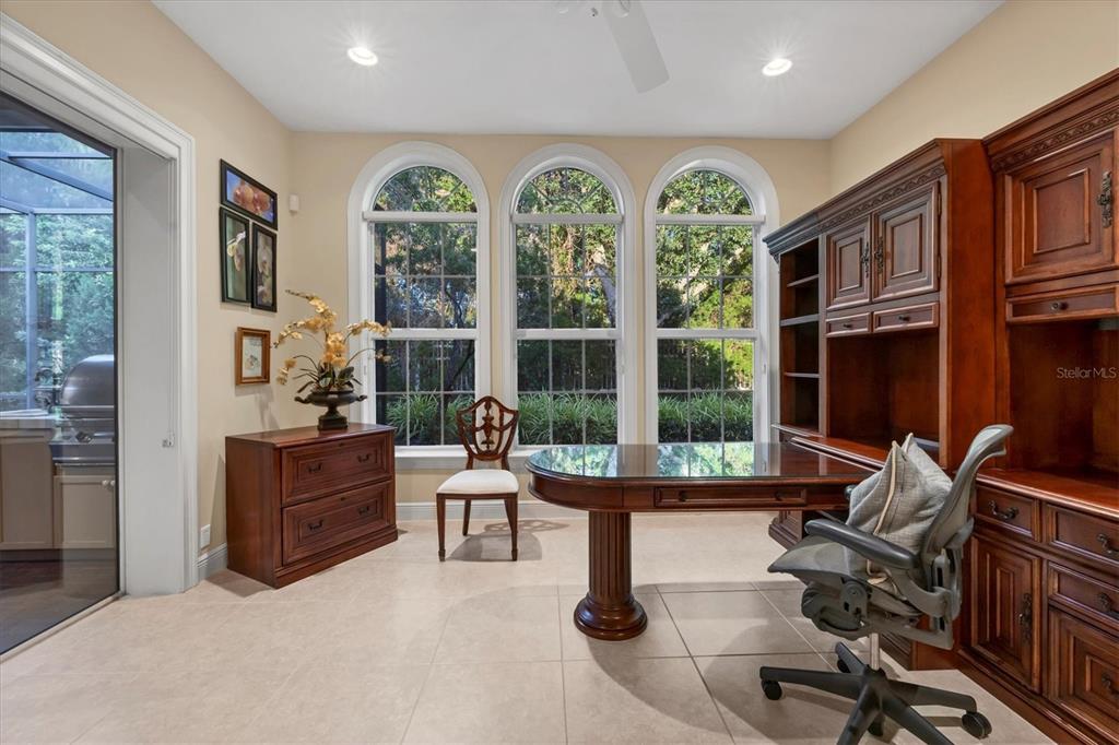 7815 Mathern Court Lakewood Ranch, FL 34202 - Photo 27 of 55 a living room with furniture fireplace and large windows