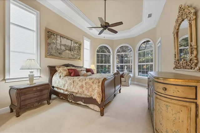 a bathroom with a granite countertop tub a sink and a large mirror