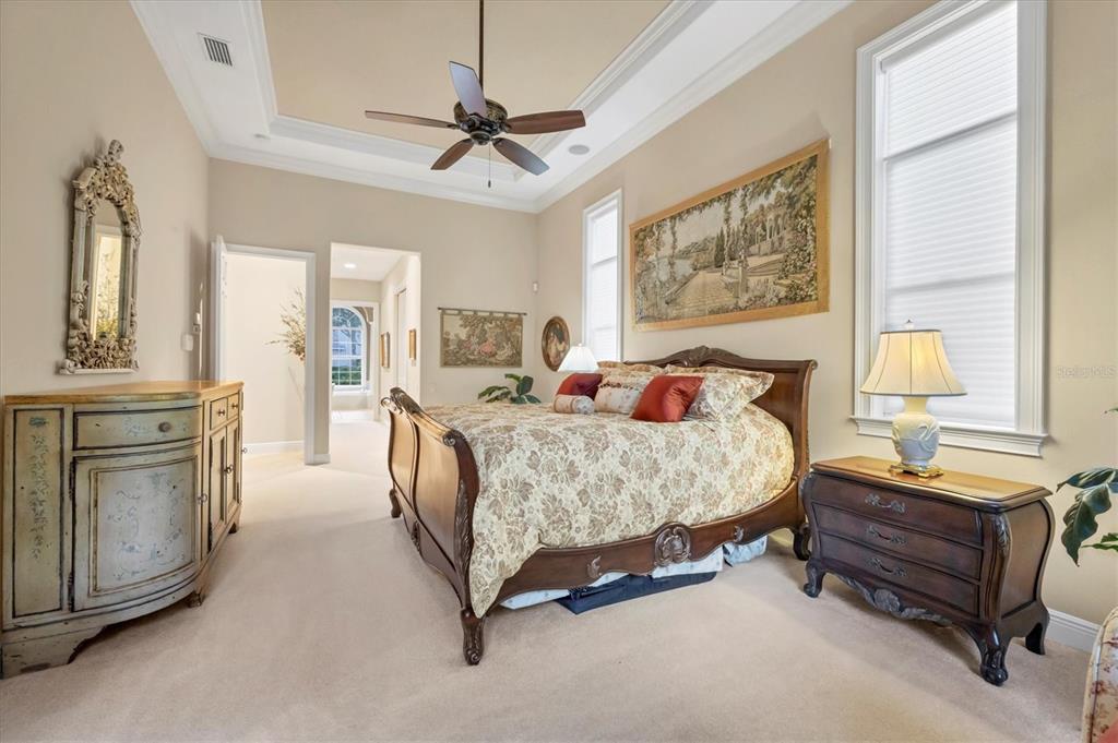 7815 Mathern Court Lakewood Ranch, FL 34202 - Photo 29 of 55 a bedroom with a bed and a chandelier