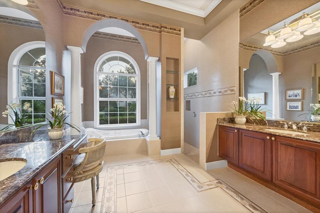 7815 Mathern Court Lakewood Ranch, FL 34202 - Photo 30 of 55 a bathroom with a granite countertop tub a sink and a large mirror