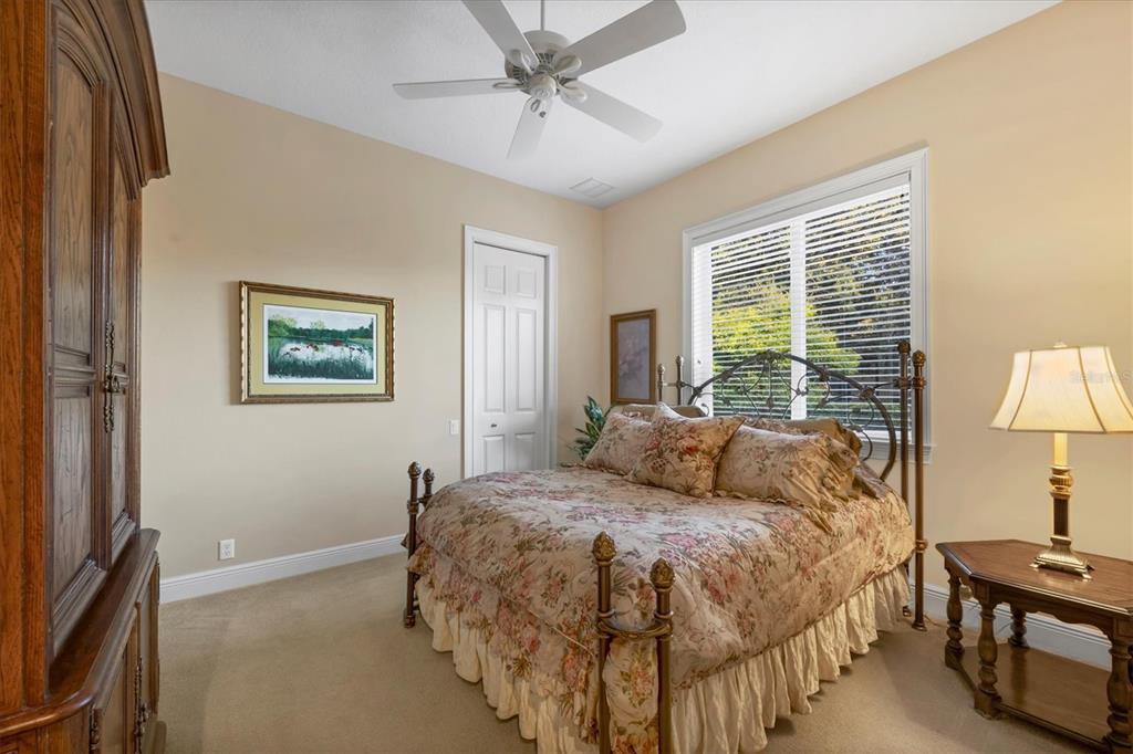 7815 Mathern Court Lakewood Ranch, FL 34202 - Photo 33 of 55 a bedroom with a bed and a lamp on table