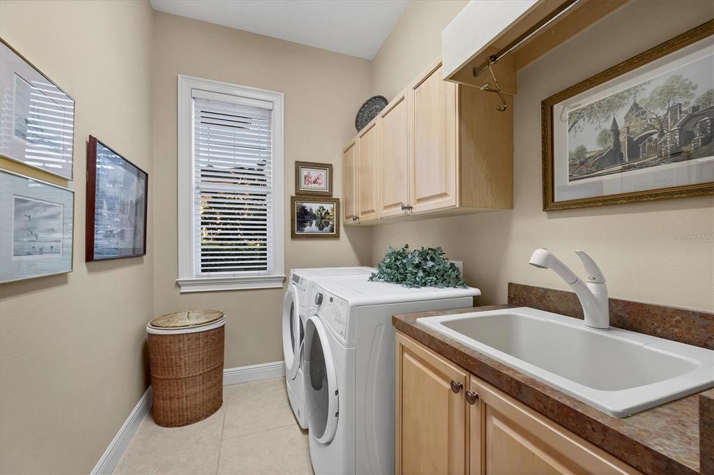 7815 Mathern Court Lakewood Ranch, FL 34202 - Photo 37 of 55 a kitchen with a sink and a washer dryer
