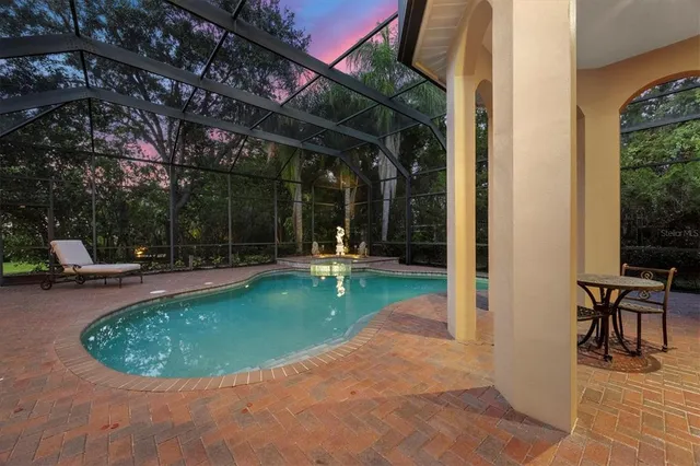 a view of a swimming pool with sitting area
