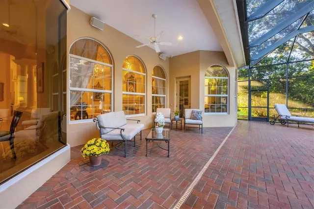 a view of a porch with dining table and chairs