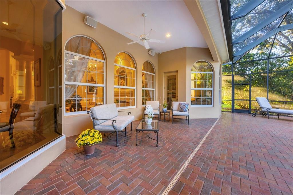 7815 Mathern Court Lakewood Ranch, FL 34202 - Photo 41 of 55 a view of a patio with table and chairs potted plants with wooden floor
