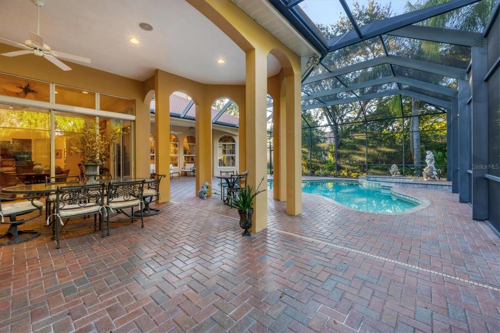 7815 Mathern Court Lakewood Ranch, FL 34202 - Photo 43 of 55 a view of a porch with dining table and chairs