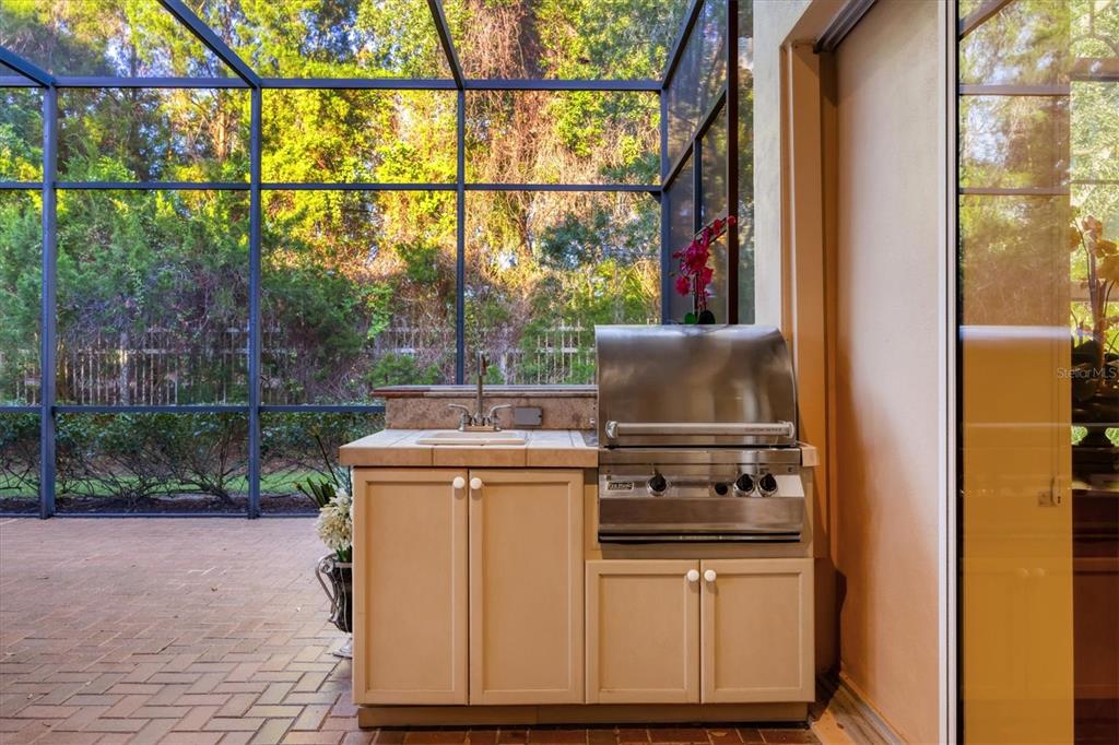 7815 Mathern Court Lakewood Ranch, FL 34202 - Photo 44 of 55 a kitchen that has a stove and a microwave