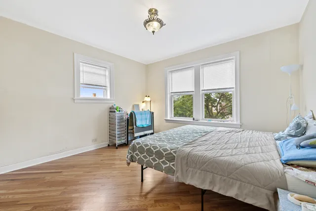 a bedroom with a bed table and a window
