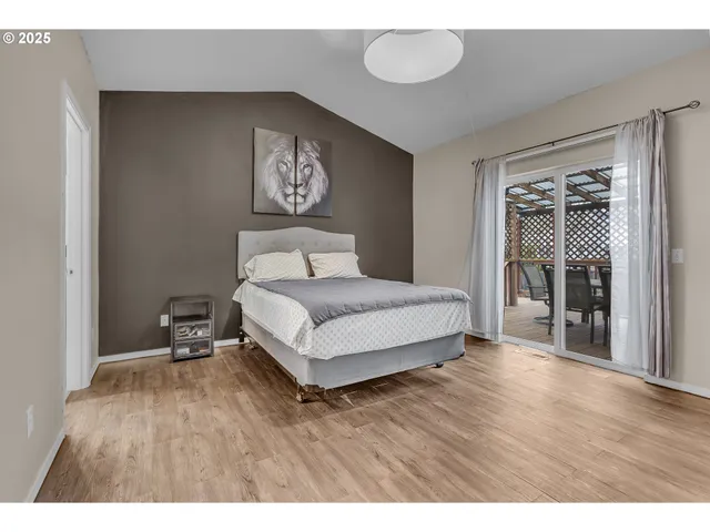 a spacious bedroom with a bed and a table