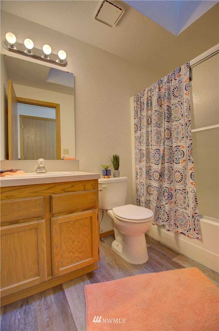 1820 Diamond Loop Southeast Lacey, WA 98503 - Photo 11 of 17 a bathroom with a toilet sink and mirror