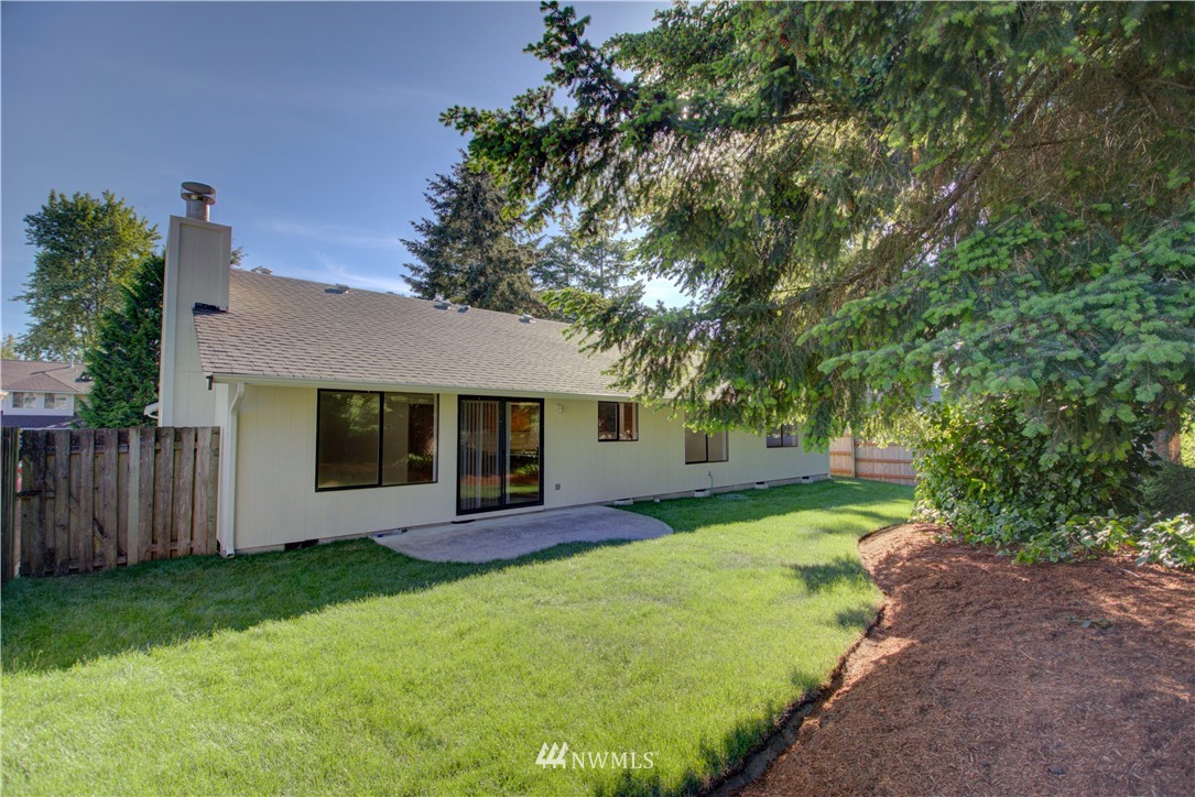 1820 Diamond Loop Southeast Lacey, WA 98503 - Photo 14 of 17 a front view of a house with a garden and yard