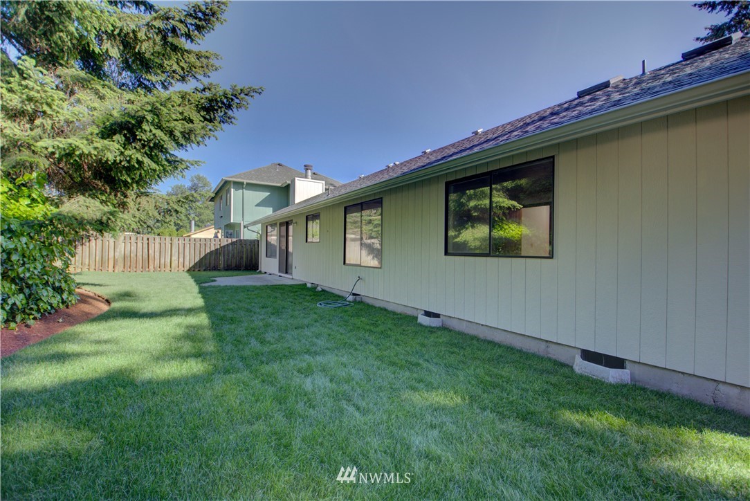 1820 Diamond Loop Southeast Lacey, WA 98503 - Photo 16 of 17 a view of a backyard with a large tree